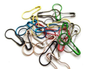 Multi-color bulb safety pins and hijab pins for secure and fabric-friendly styling.